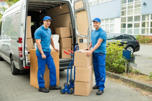 Careful loading of large furniture items for transport in Barnes